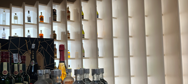 Illuminated liquor bottle display racks with vertical shelf compartments