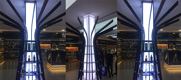 Liquor bottle display rack in a modern Indian wine shop for better product visibility, New Delhi