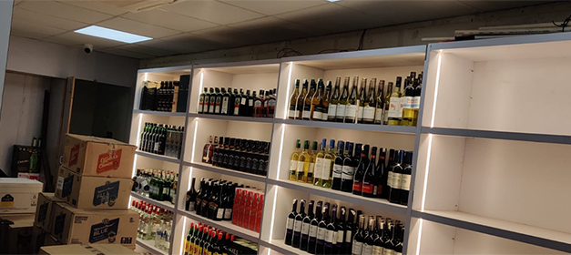 Liquor bottle display rack in Indian wine shop, New Delhi