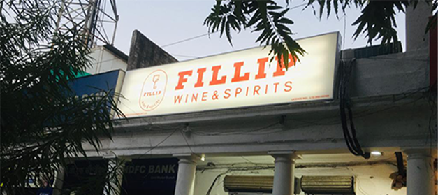 Liquor bottle display rack in a modern Indian wine shop for better product visibility, New Delhi